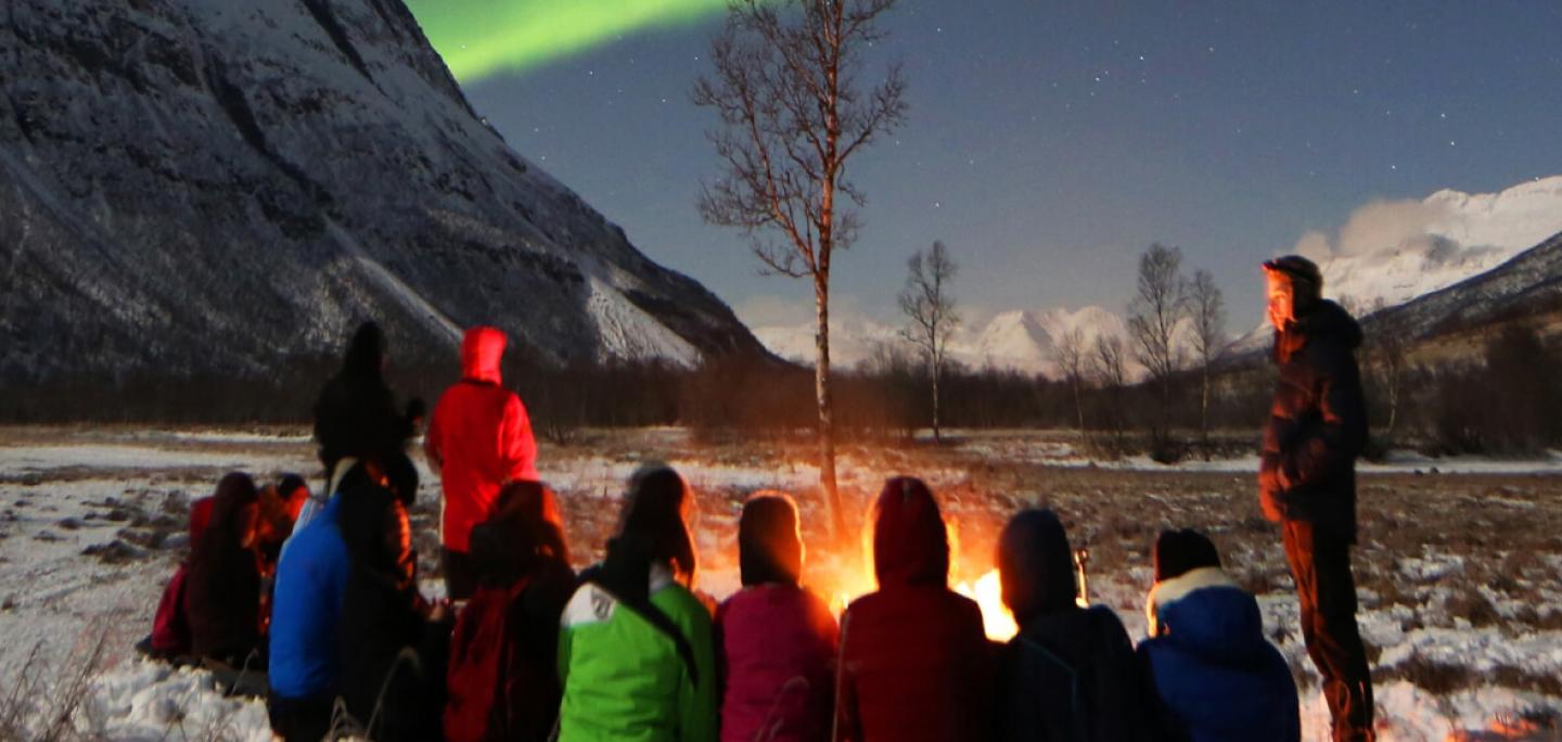 small group watching the northern lights 