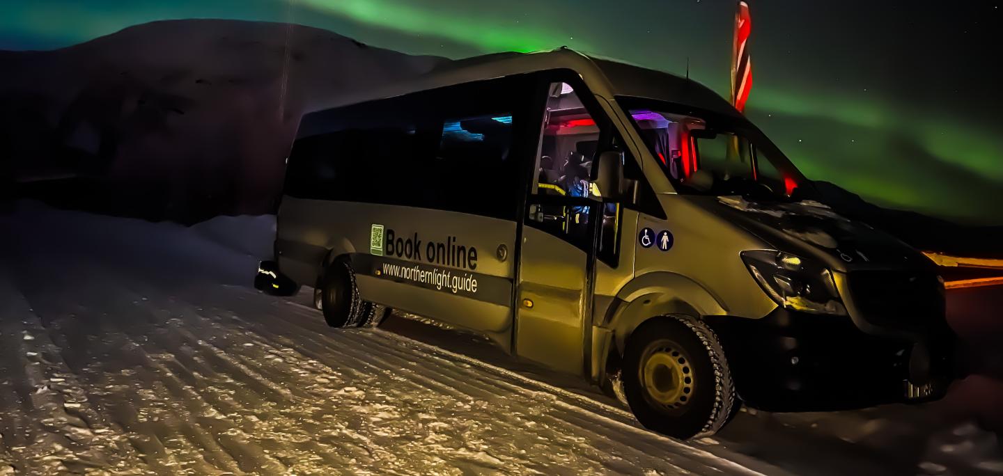 Picture of the minibus under the northern lights. 